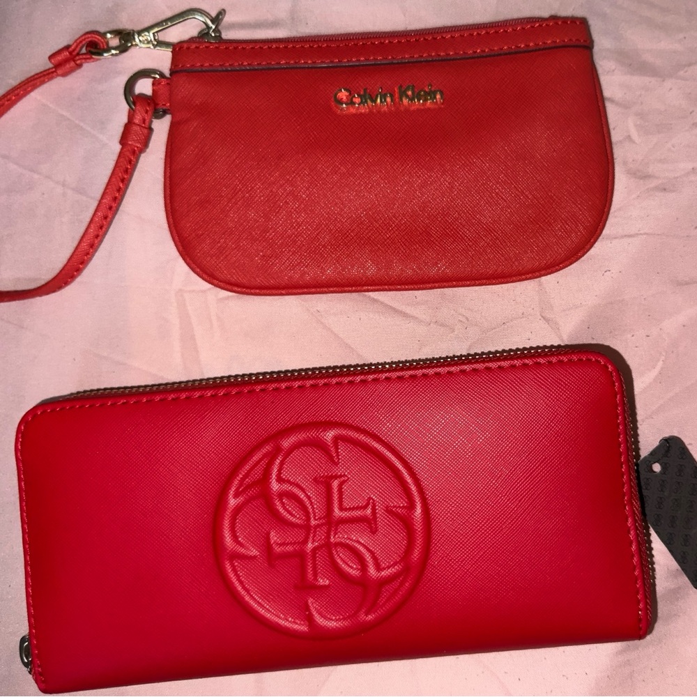 Two wallets Calvin Klein and guess one is new with tags great condition
